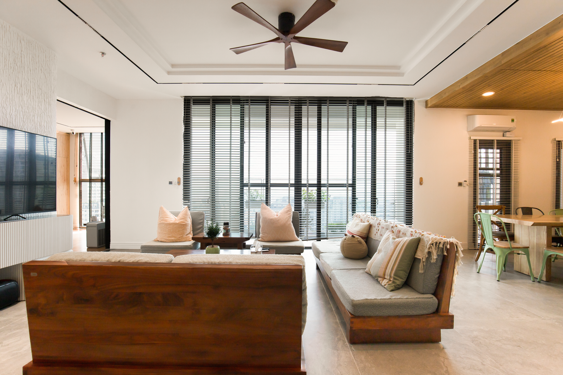 Spacious and stylish living room featuring large windows and modern decor elements.